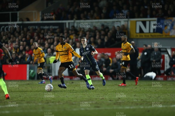 160219 - Newport County v Manchester City, FA Cup Fifth Round - Tyreeq Bakinson of Newport County takes on Phil Foden of Manchester City