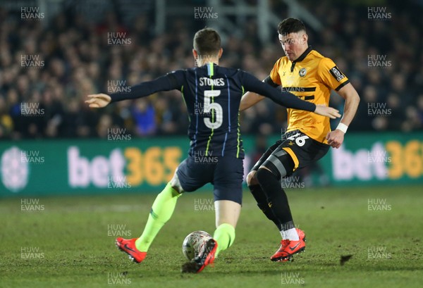 160219 - Newport County v Manchester City, FA Cup Fifth Round - Regan Poole of Newport County takes on John Stones of Manchester City