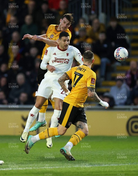280124 - Newport County v Manchester United - FA Cup, Fourth Round - Ryan Delaney of Newport County gets above Diogo Dalot of Manchester United 