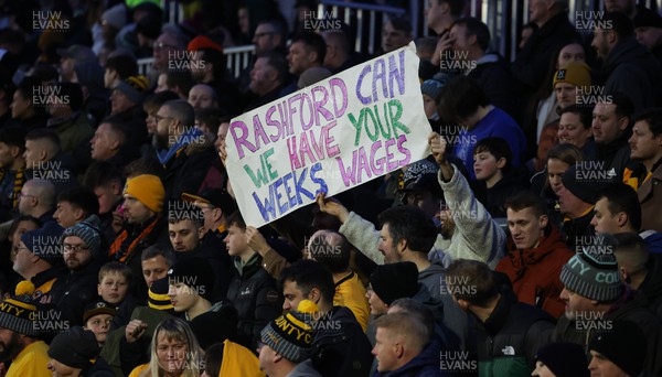 280124 - Newport County v Manchester United, FA Cup Fourth Round - Newport humour as fans hold up a sign during the match