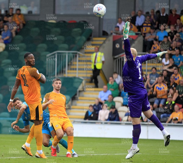 030819 - Newport County v Mansfield Town, Sky Bet League 2 - Padraig Amond of Newport County (centre) heads the ball over Conrad Logan of Mansfield Town into the net only for the goal to be ruled offside 