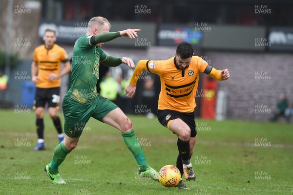 090219 - Newport County v Mansfield Town - Sky Bet League 2 -  Padraig Amond of Newport County is tackled by Neal Bishop of Mansfield Town