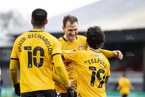 190222 - Newport County v Mansfield Town - Sky Bet League 2 - Mickey Demetriou of Newport County celebrates his side's first goal with scorer Dom Telford