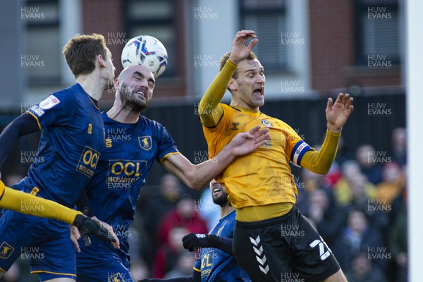 190222 - Newport County v Mansfield Town - Sky Bet League 2 - Mickey Demetriou of Newport County (R) in action against Farrend Rawson of Mansfield Town (C)