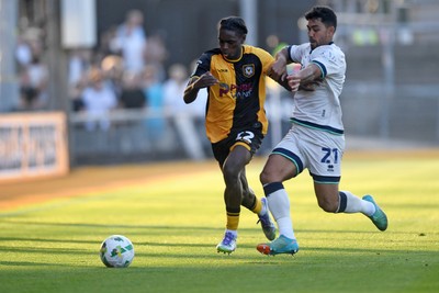 120825 - Newport County v Millwall - Carabao Cup Round 1 - Habeeb Ogunneye of Newport County is challenged by Massimo Luongo of Millwall