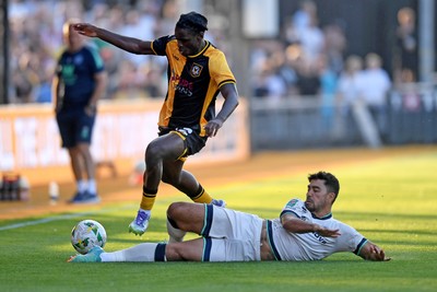 120825 - Newport County v Millwall - Carabao Cup Round 1 - Habeeb Ogunneye of Newport County is challenged by Massimo Luongo of Millwall