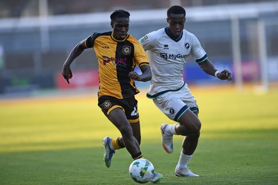 120825 - Newport County v Millwall - Carabao Cup Round 1 - Habeeb Ogunneye of Newport County is challenged by Aidomo Emakhu of Millwall