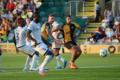 120825 - Newport County v Millwall - Carabao Cup Round 1 - James Clarke of Newport County watches the ball as he heads it on target