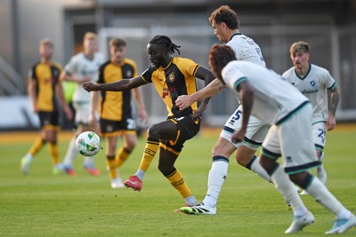 120825 - Newport County v Millwall - Carabao Cup Round 1 - Cameron Antwi of Newport County is challenged by Jake Cooper of Millwall