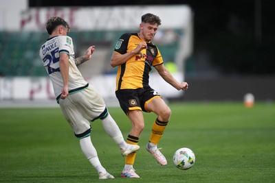 120825 - Newport County v Millwall - Carabao Cup Round 1 - Ben Lloyd of Newport County is challenged by Luke Cundle of Millwall