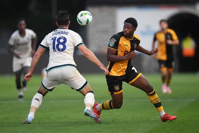120825 - Newport County v Millwall - Carabao Cup Round 1 - Bobby Kamwa of Newport County is challenged by Ryan Leonard of Millwall