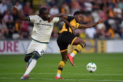 120825 - Newport County v Millwall - Carabao Cup Round 1 - Bobby Kamwa of Newport County is challenged by Kamarl Grant of Millwall