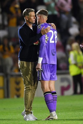 120825 - Newport County v Millwall - Carabao Cup Round 1 - Newport County Manager, David Hughes with Jordan Wright of Newport County at full time