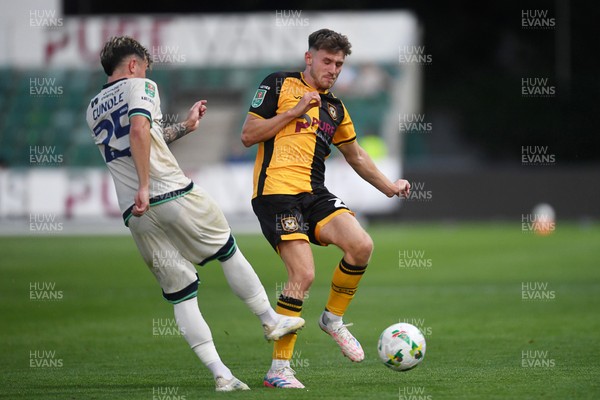 120825 - Newport County v Millwall - Carabao Cup Round 1 - Ben Lloyd of Newport County is challenged by Luke Cundle of Millwall