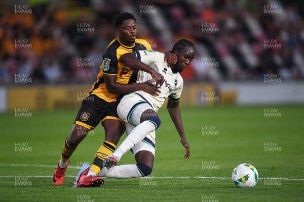 120825 - Newport County v Millwall - Carabao Cup Round 1 - Bobby Kamwa of Newport County is challenged by Macaulay Langstaff of Millwall
