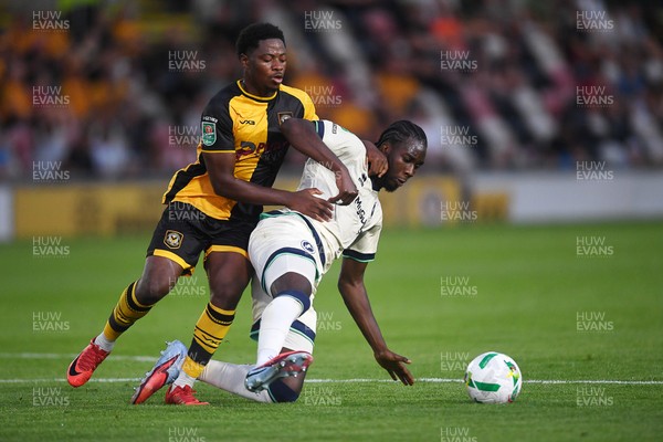 120825 - Newport County v Millwall - Carabao Cup Round 1 - Bobby Kamwa of Newport County is challenged by Macaulay Langstaff of Millwall