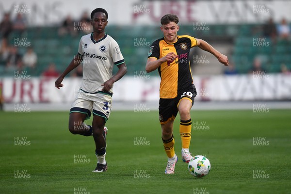 120825 - Newport County v Millwall - Carabao Cup Round 1 - Ben Lloyd of Newport County is challenged by Ra'ees Bangura-Williams of Millwall