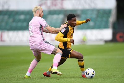 230825 - Newport County v Milton Keynes Dons - Sky Bet League 2 - Bobby Kamwa of Newport County is challenged by Gethin Jones of MK Dons