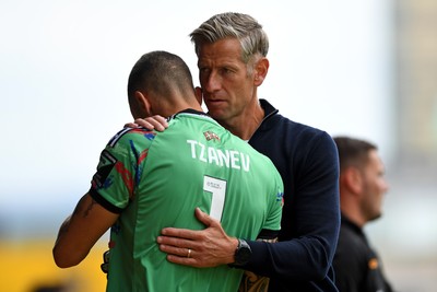 230825 - Newport County v Milton Keynes Dons - Sky Bet League 2 - Newport County Manager, David Hughes with Nik Tzanev of Newport County before the match