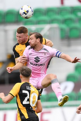 230825 - Newport County v Milton Keynes Dons - Sky Bet League 2 - Lee Jenkins of Newport County is challenged by Callum Paterson of MK Dons