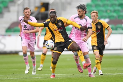 230825 - Newport County v Milton Keynes Dons - Sky Bet League 2 - Cameron Antwi of Newport County is challenged by Callum Paterson of MK Dons