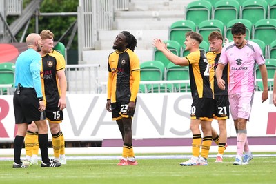 230825 - Newport County v Milton Keynes Dons - Sky Bet League 2 - Referee, Stuart Morland awards a penalty to MK Dons
