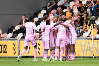 230825 - Newport County v Milton Keynes Dons - Sky Bet League 2 - Callum Paterson of MK Dons celebrates scoring a goal with team mates
