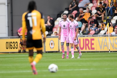 230825 - Newport County v Milton Keynes Dons - Sky Bet League 2 - Callum Paterson of MK Dons celebrates scoring a goal with team mates