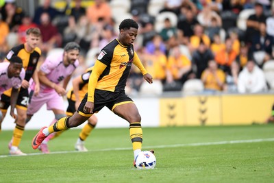 230825 - Newport County v Milton Keynes Dons - Sky Bet League 2 - Bobby Kamwa of Newport County has his penalty saved by Craig MacGillivray of MK Dons