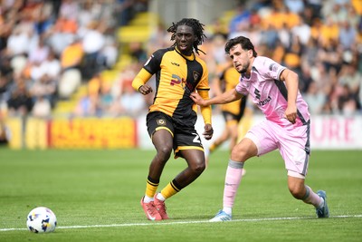 230825 - Newport County v Milton Keynes Dons - Sky Bet League 2 - Michael Reindorf of Newport County is challenged by Jack Sanders of MK Dons