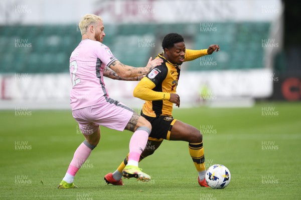 230825 - Newport County v Milton Keynes Dons - Sky Bet League 2 - Bobby Kamwa of Newport County is challenged by Gethin Jones of MK Dons