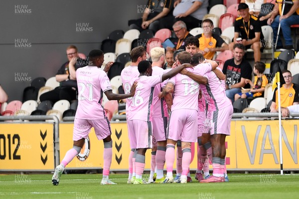 230825 - Newport County v Milton Keynes Dons - Sky Bet League 2 - Callum Paterson of MK Dons celebrates scoring a goal with team mates