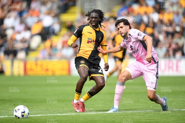 230825 - Newport County v Milton Keynes Dons - Sky Bet League 2 - Michael Reindorf of Newport County is challenged by Jack Sanders of MK Dons