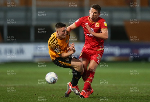 070120 - Newport County v MK Dons - Leasingcom Trophy - Dom Jeffries of Newport County is tackled by Jordan Houghton of MK Dons