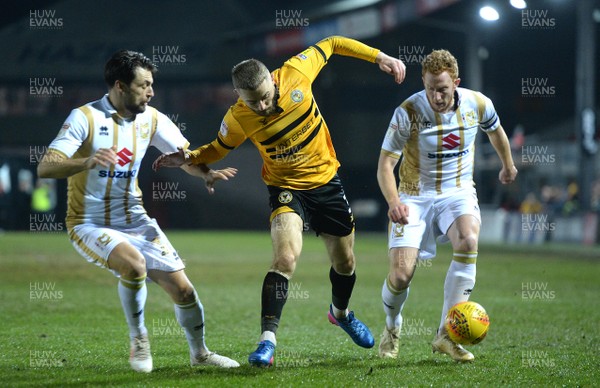 120219 - Newport County v MK Dons - SkyBet League 2 - Dan Butler of Newport County is tackled by Russell Martin and Dean Lewington of MK Dons