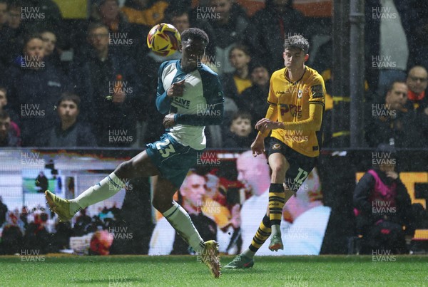 040225  Newport County v Morecambe, EFL Sky Bet League 2 - Joe Thomas of Newport County crosses the ball past David Tutonda of Morecambe