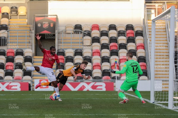 051220 - Newport County v Morecambe - Sky Bet League 2 - Yann Songo'o of Morecambe clears under pressure from Scott Twine of Newport County