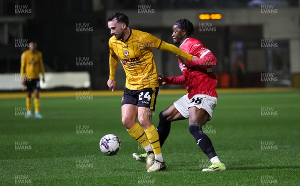 120324 - Newport County v Morecambe, EFL Sky Bet League 2 - Aaron Wildig of Newport County is challenged by Nelson Khumbeni of Morecambe