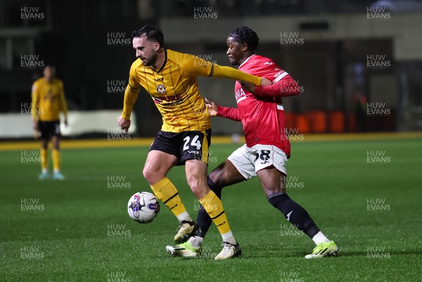 120324 - Newport County v Morecambe, EFL Sky Bet League 2 - Aaron Wildig of Newport County is challenged by Nelson Khumbeni of Morecambe