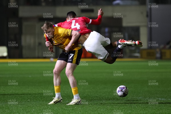120324 - Newport County v Morecambe, EFL Sky Bet League 2 - Will Evans of Newport County is challenged by Jacob Bedeau of Morecambe