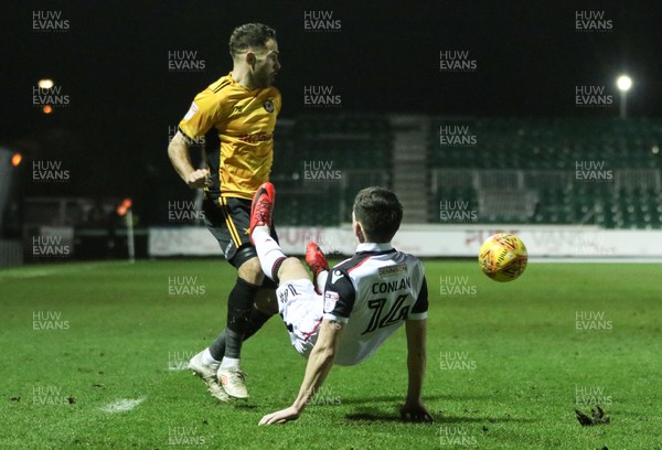 230118 - Newport County v Morecambe, SkyBet League 2 - Robbie Willmott of Newport County and Luke Conlan of Morecambe compete for the ball
