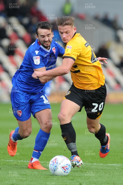 271018 - Newport County v Morecambe  Rovers - Sky Bet League 2 - Cameron Pring of Newport County holds off the challenge of Aaron Wildig of Morecambe  
