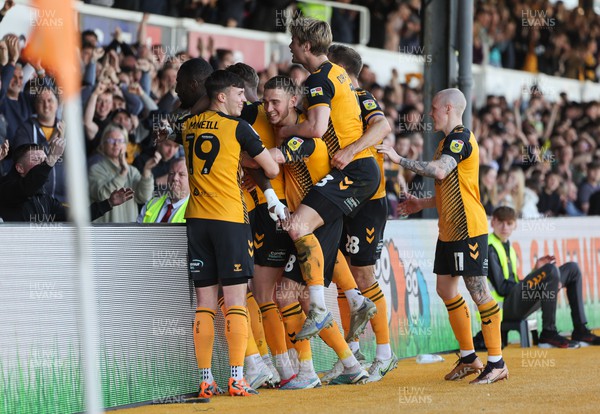 070423 - Newport County v Northampton Town, EFL Sky Bet League 2 - Omar Bogle of Newport County is mobbed by teammates as he celebrates after he scores the second goal from the penalty spot
