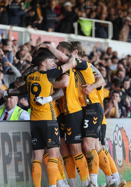 070423 - Newport County v Northampton Town, EFL Sky Bet League 2 - Omar Bogle of Newport County is mobbed by teammates as he celebrates after he scores the second goal from the penalty spot