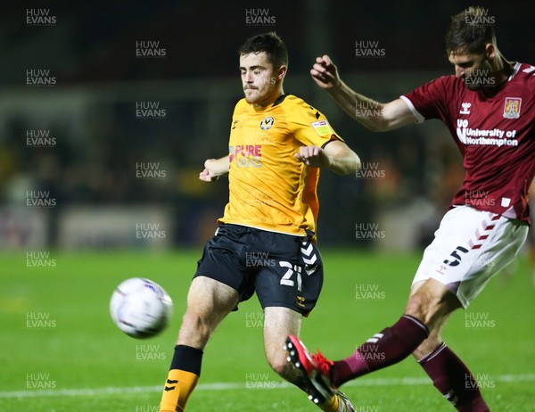 140921 - Newport County v Northampton Town, Sky Bet League 2 - Jon Guthrie of Northampton Town clears as Lewis Collins of Newport County closes in