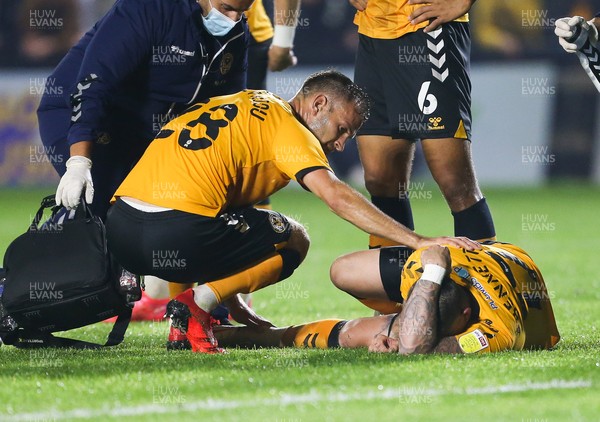 140921 - Newport County v Northampton Town, Sky Bet League 2 -Scot Bennett of Newport County is comforted by Mickey Demetriou of Newport County after he is injured