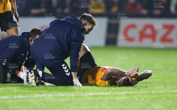 140921 - Newport County v Northampton Town, Sky Bet League 2 -Scot Bennett of Newport County receives treatment before being stretchered off after he is injured