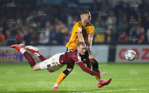 140921 - Newport County v Northampton Town, Sky Bet League 2 - Mitch Pinnock of Northampton Town loses out to Cameron Norman of Newport County as he looks to head at goal
