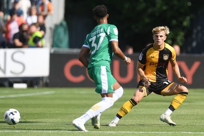 020825 - Newport County v Notts County - Sky Bet League 2 - Tom Davies of Newport County is challenged by Barry Cotter of Notts County
