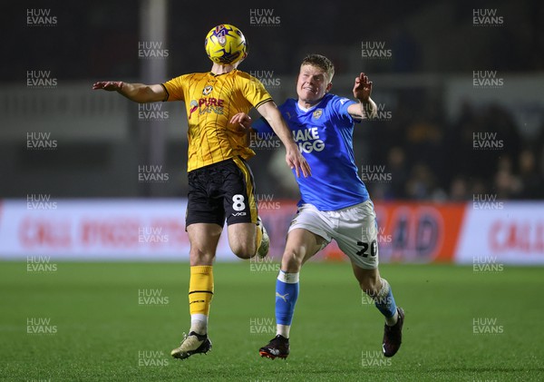 130224 - Newport County v Notts County - SkyBet League Two - Bryn Morris of Newport County is challenged by Scott Robertson of Notts County 